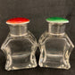 A pair of antique silver and enamel topped perfume bottles