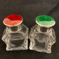 A pair of antique silver and enamel topped perfume bottles