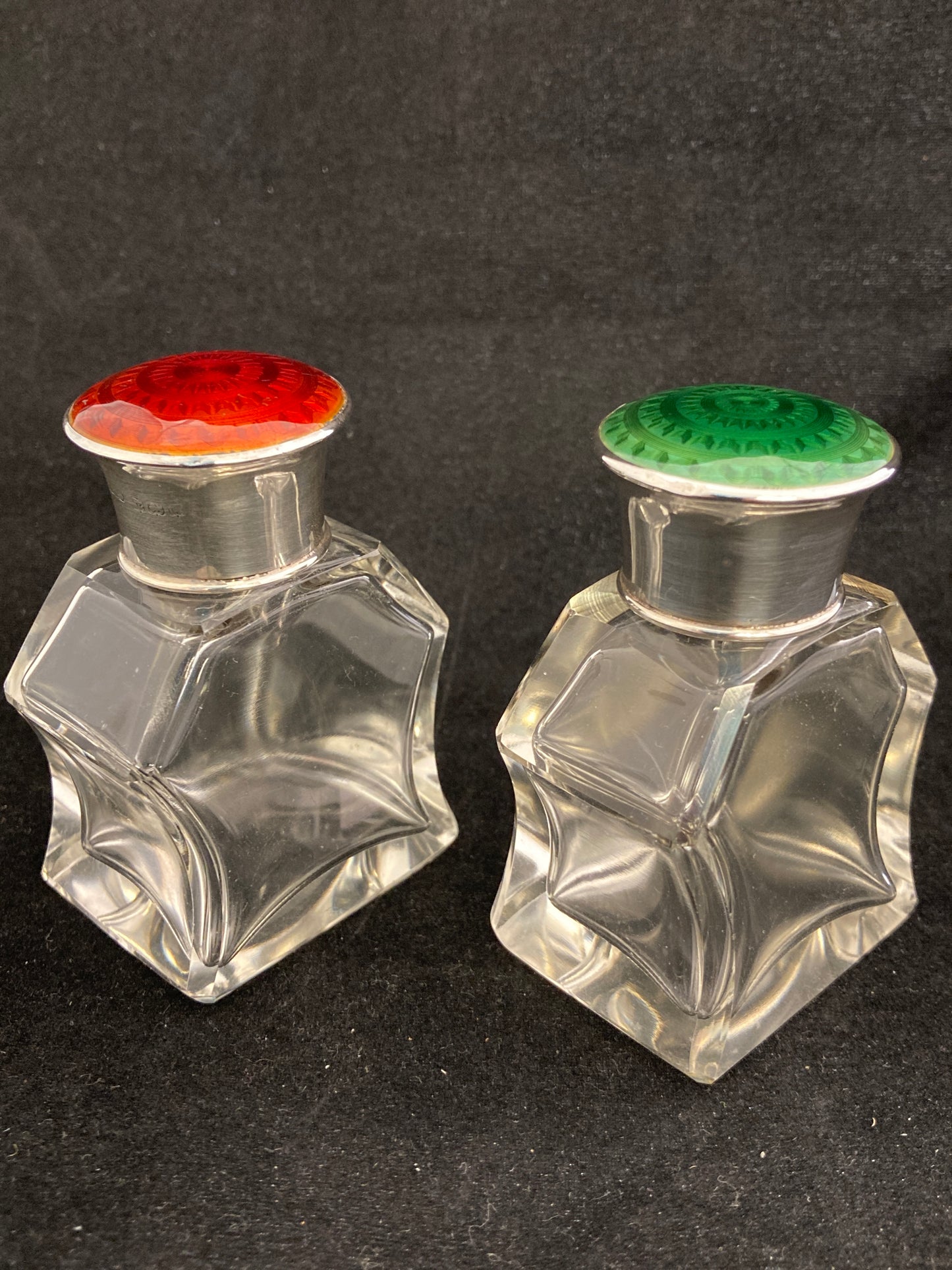 A pair of antique silver and enamel topped perfume bottles