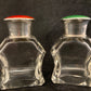 A pair of antique silver and enamel topped perfume bottles