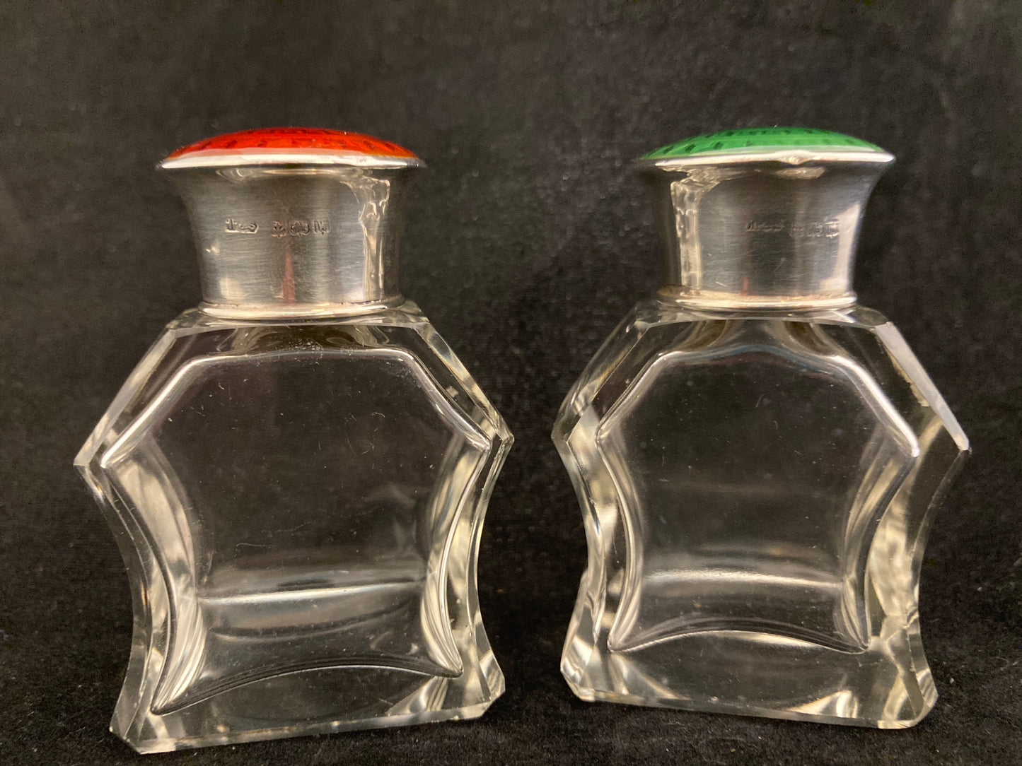 A pair of antique silver and enamel topped perfume bottles