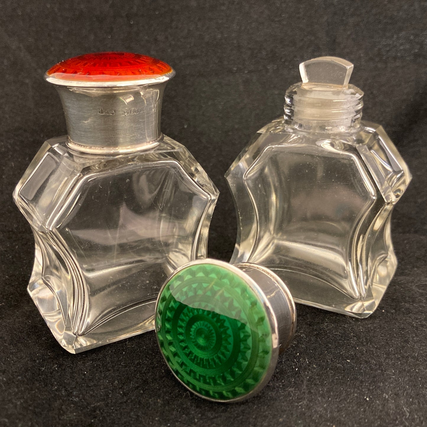 A pair of antique silver and enamel topped perfume bottles