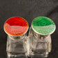 A pair of antique silver and enamel topped perfume bottles