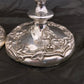 A pair of antique silver plated candlesticks
