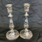 A pair of antique silver plated candlesticks