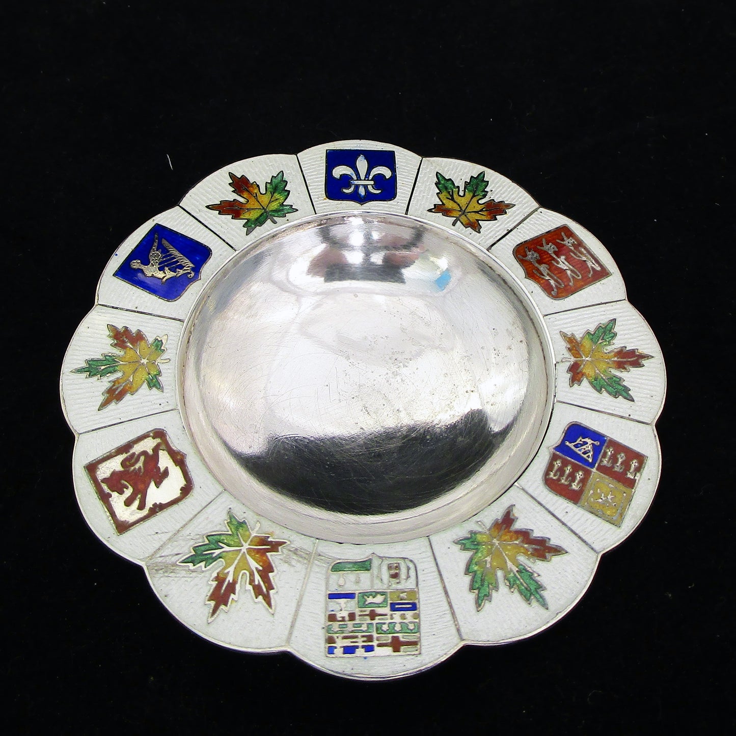 A silver and enamel ring tray.