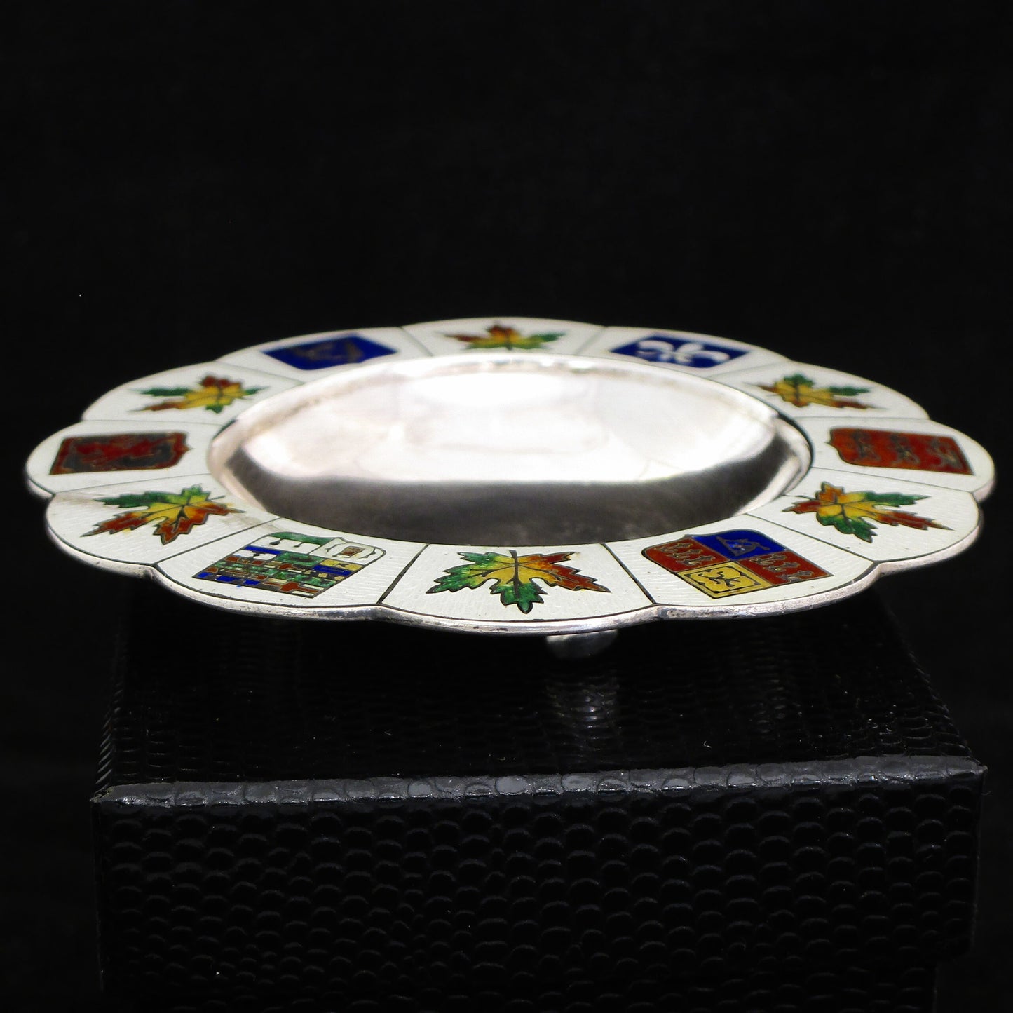A silver and enamel ring tray.
