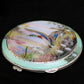 Silver and enamel compact with hand painted ducks.