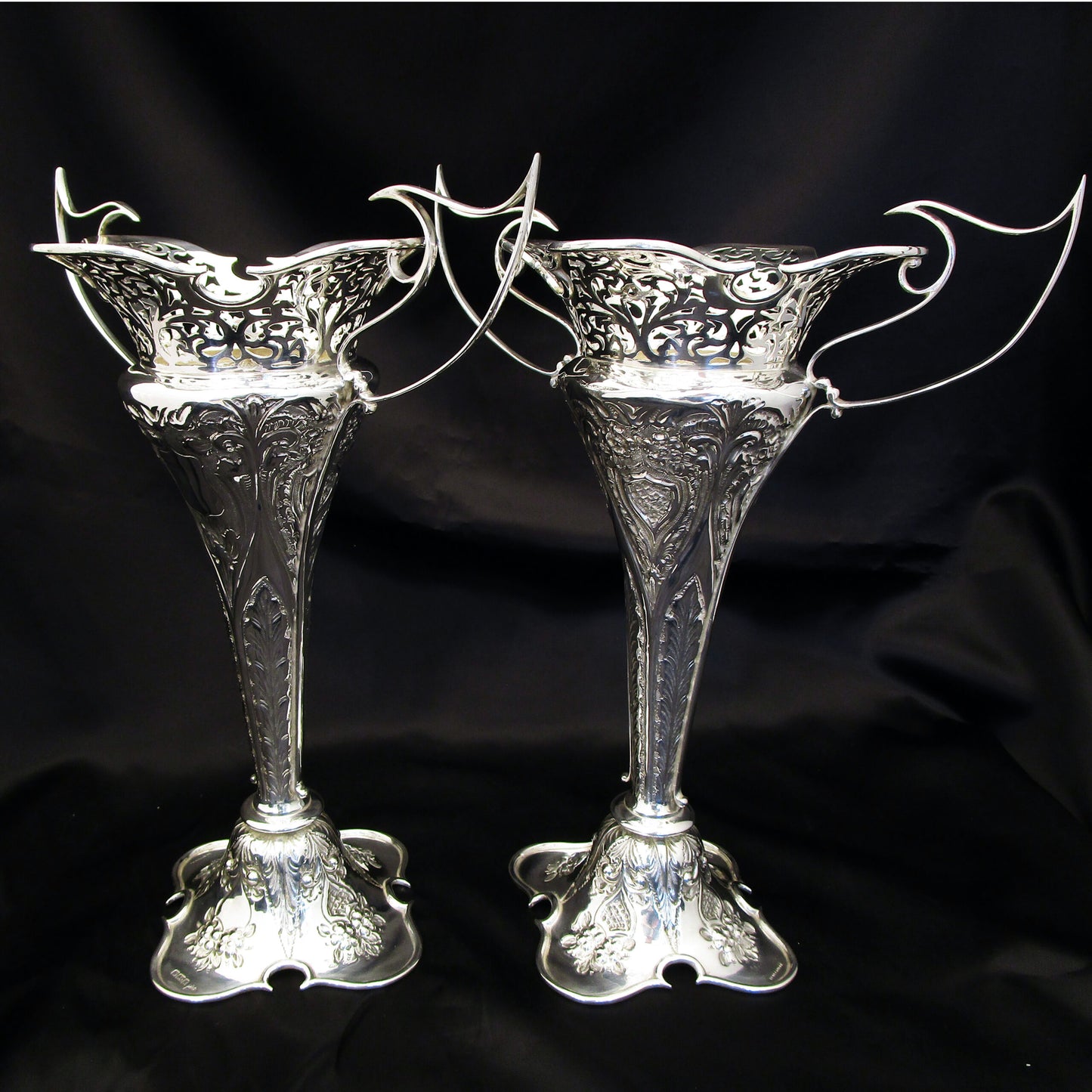 A pair of large sterling silver pierced and embossed vases by Walker & Hall.