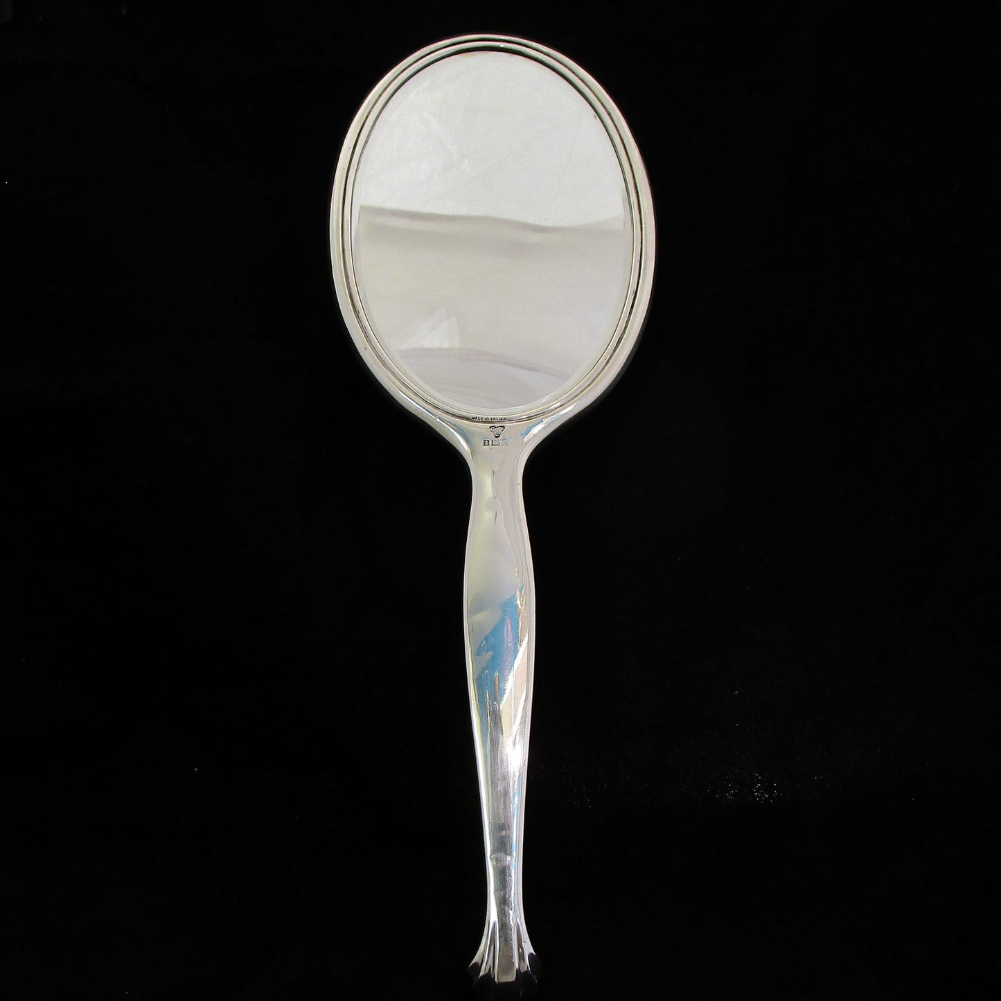 A sterling silver and enamel hand mirror.