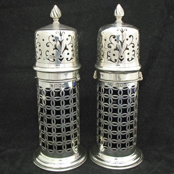 A rare pair of silver sugar shakers with blue liners.