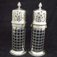 A rare pair of silver sugar shakers with blue liners.