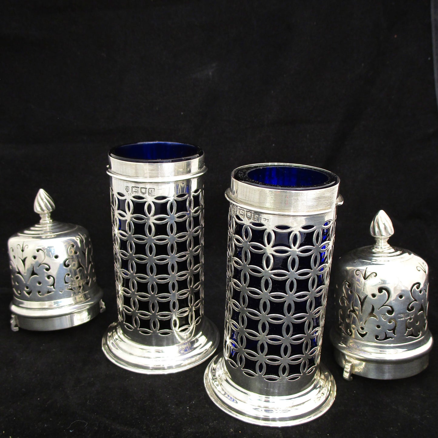 A rare pair of silver sugar shakers with blue liners.