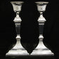 A pair of sterling silver Georgian style candle sticks.