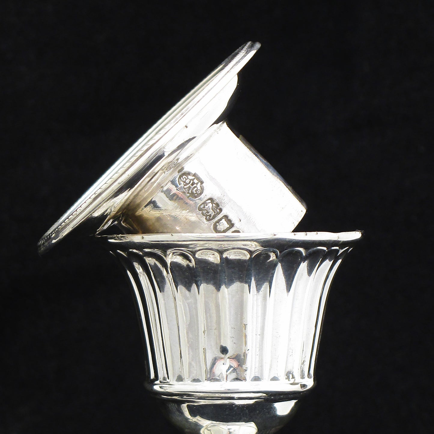 A pair of sterling silver Georgian style candle sticks.