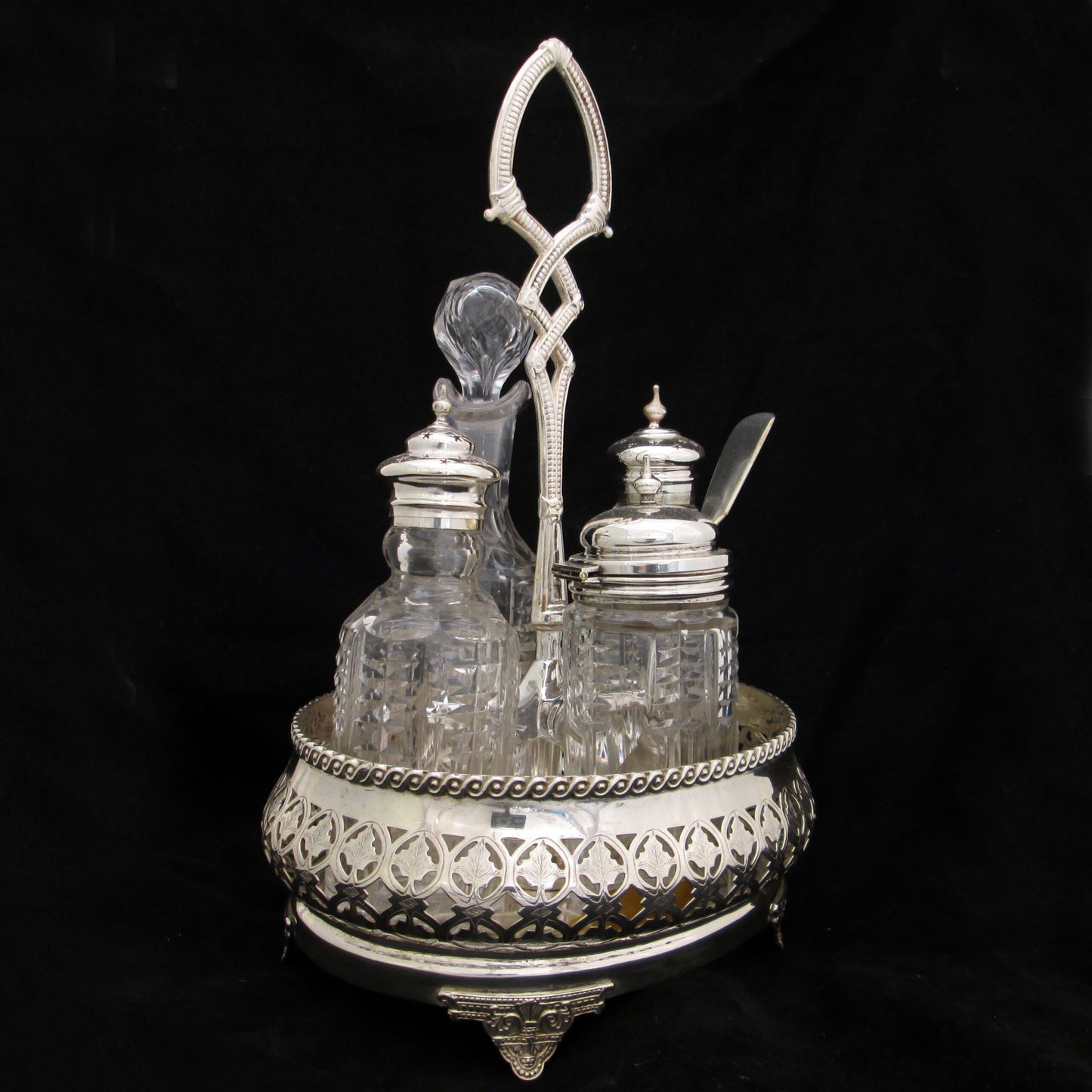 Silver plated cruet set in gallery base.