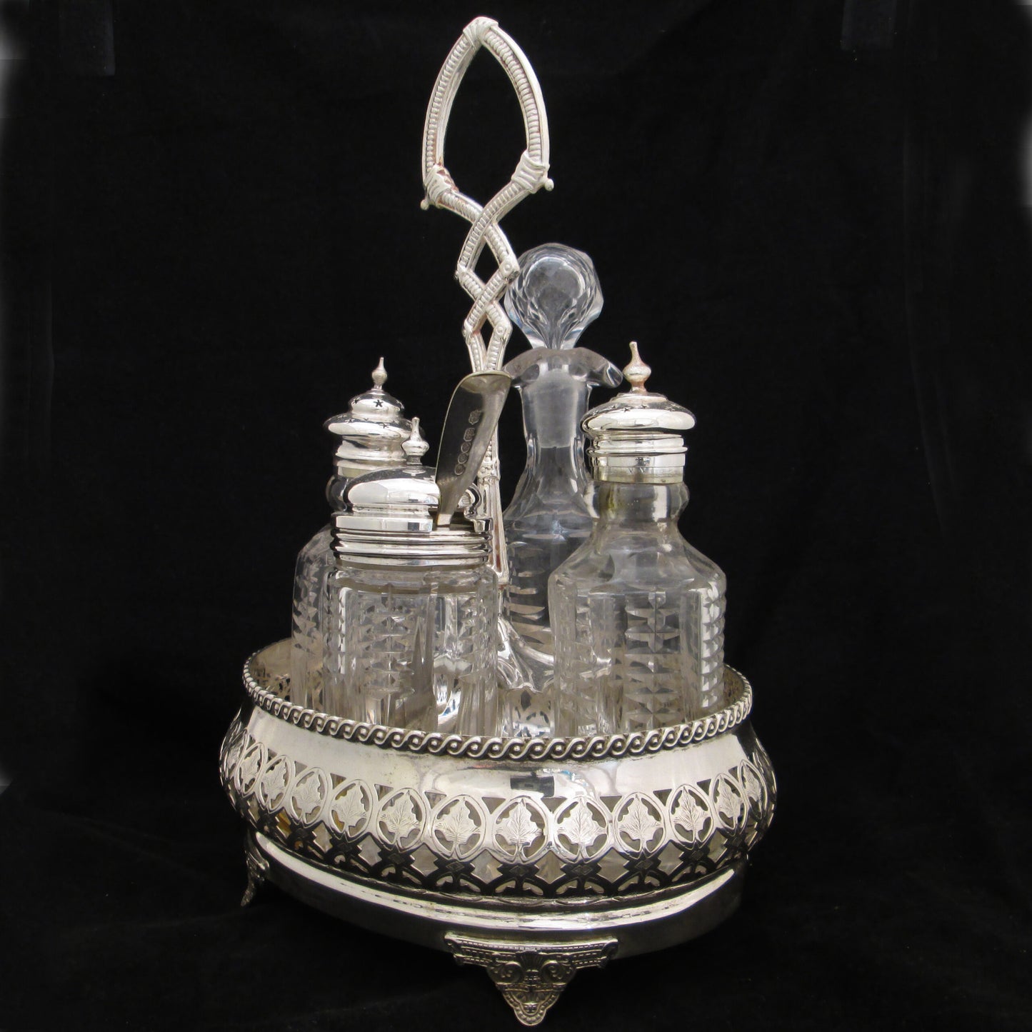 Silver plated cruet set in gallery base.