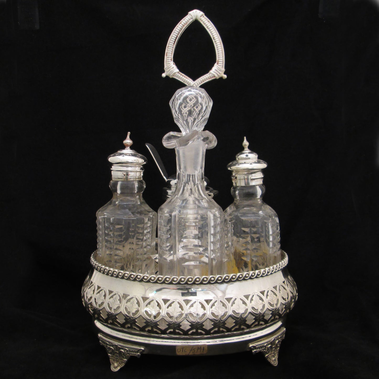 Silver plated cruet set in gallery base.