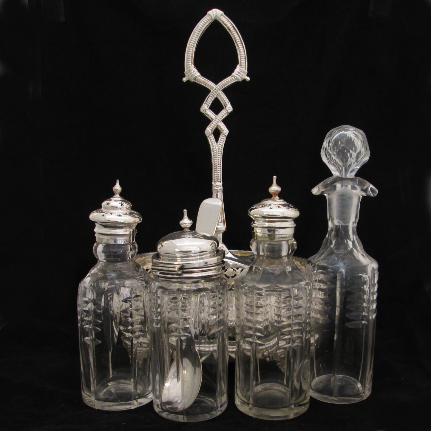 Silver plated cruet set in gallery base.