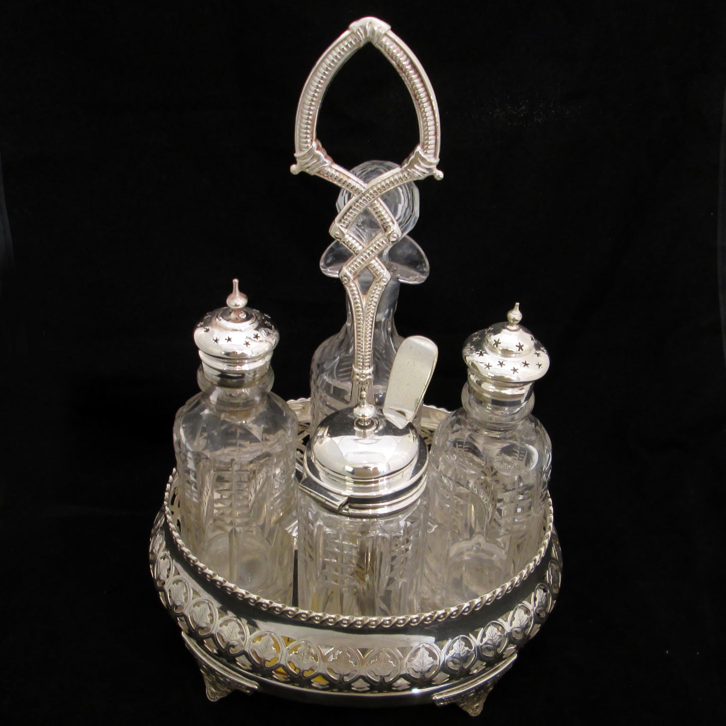 Silver plated cruet set in gallery base.