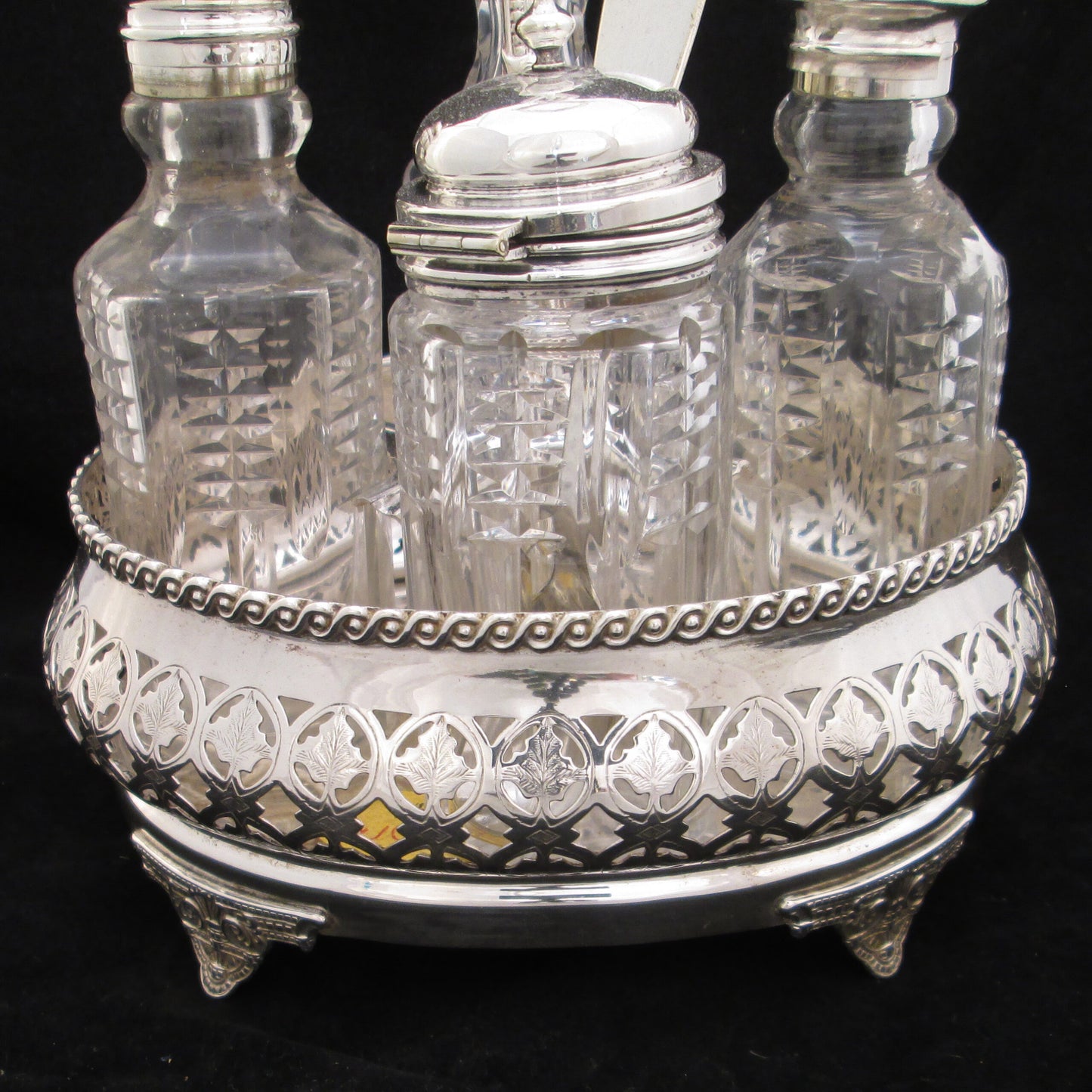 Silver plated cruet set in gallery base.