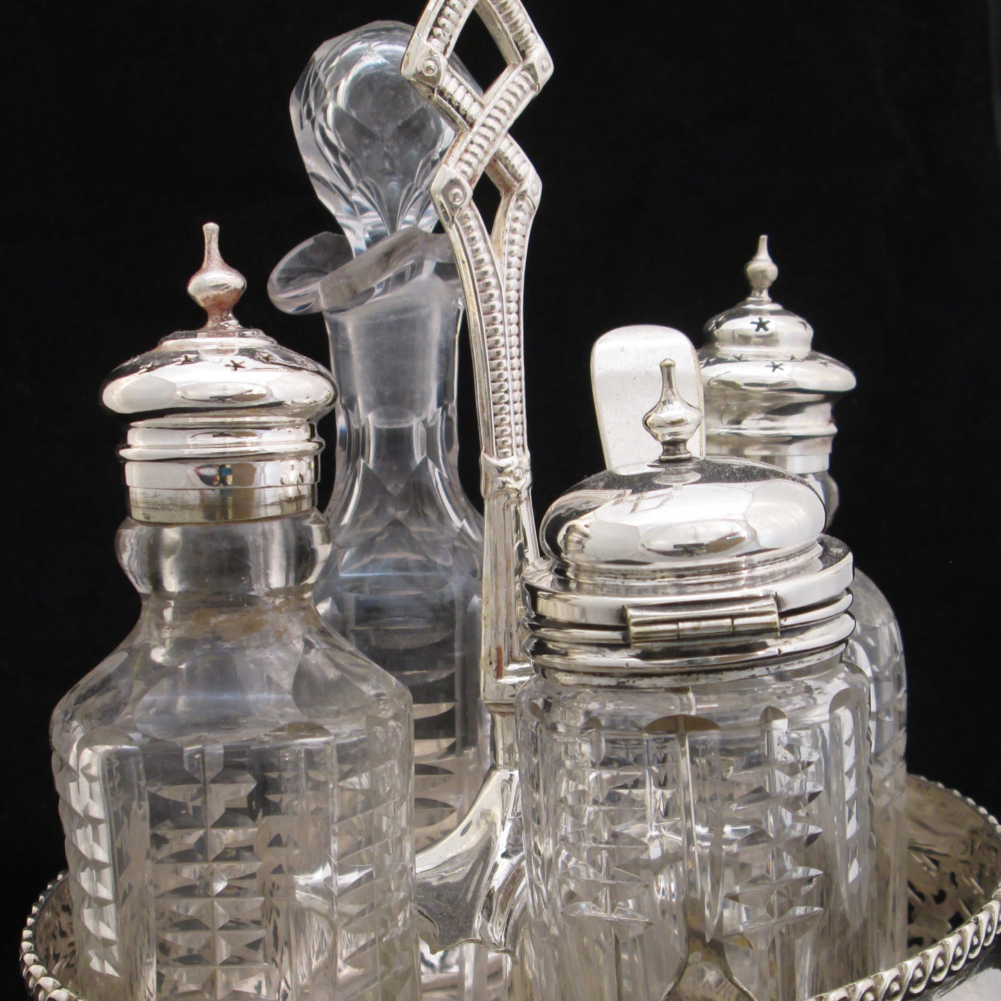 Silver plated cruet set in gallery base.