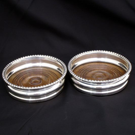 A pair of Georgian silver wine coasters