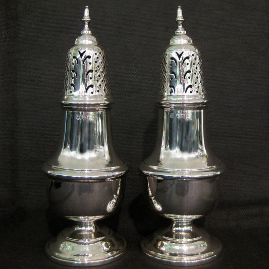 A pair of silver sugar castors.