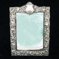 Sterling silver ornate table mirror/picture frame.