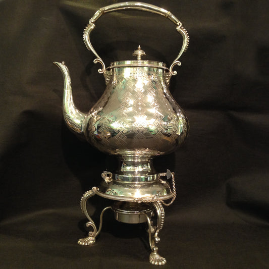 A silver plated Kettle on stand.