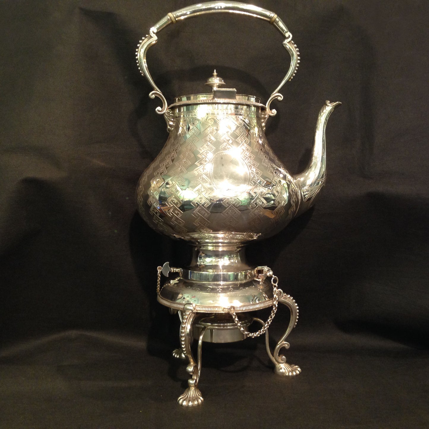 A silver plated Kettle on stand.