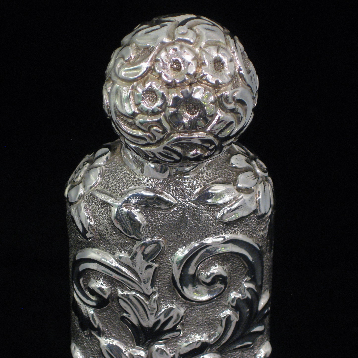 Highly decorative sterling silver perfume bottle.
