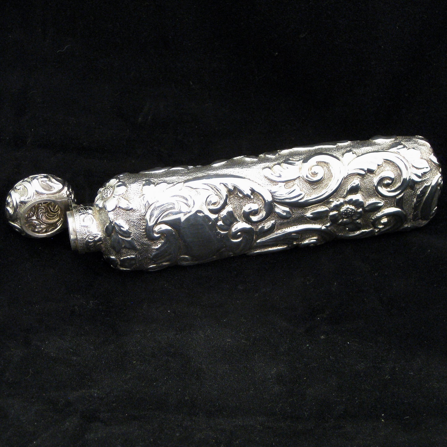 Highly decorative sterling silver perfume bottle.