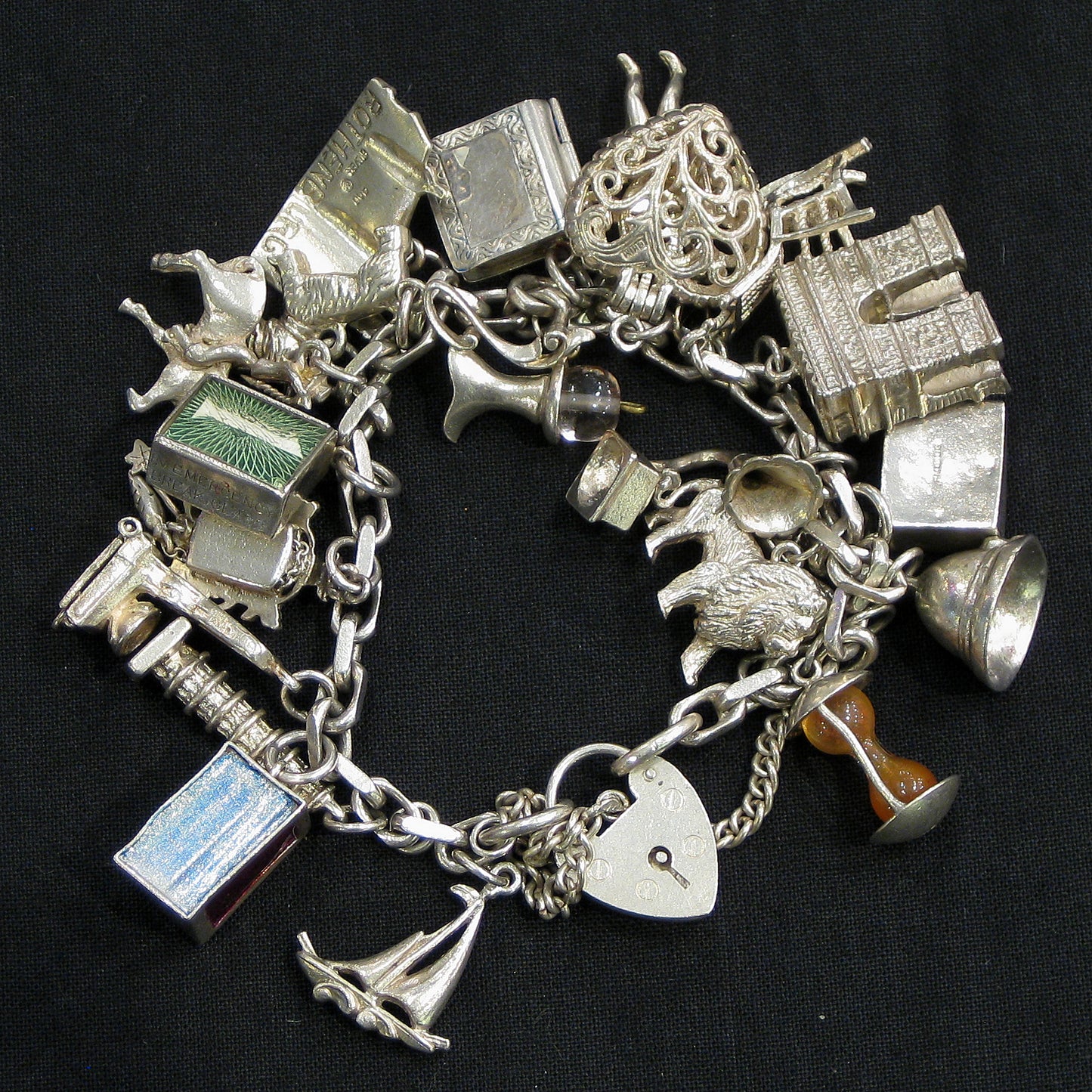 Silver charm bracelet with assorted charms.