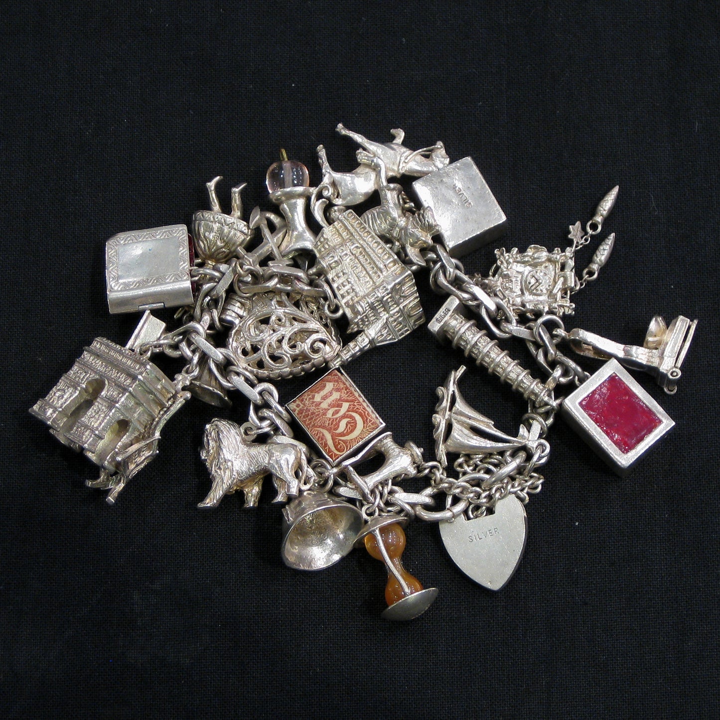 Silver charm bracelet with assorted charms.