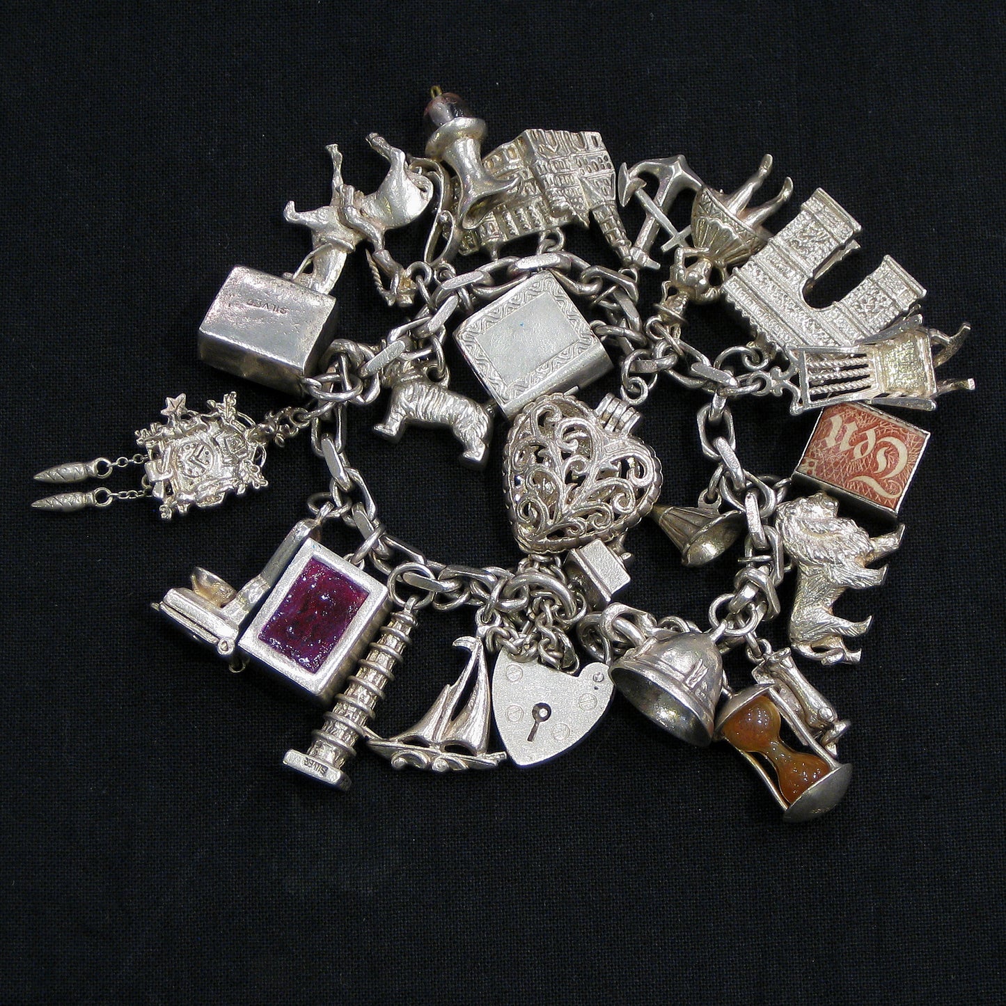 Silver charm bracelet with assorted charms.