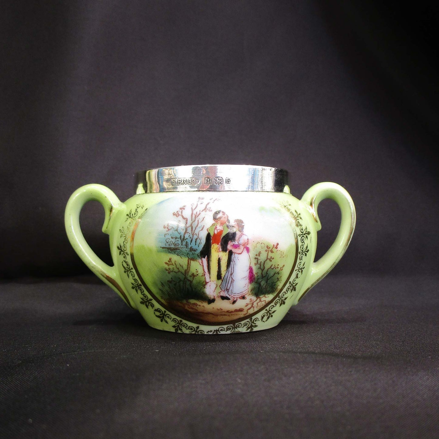 Antique hand painted porcelain tea set with silver rims.