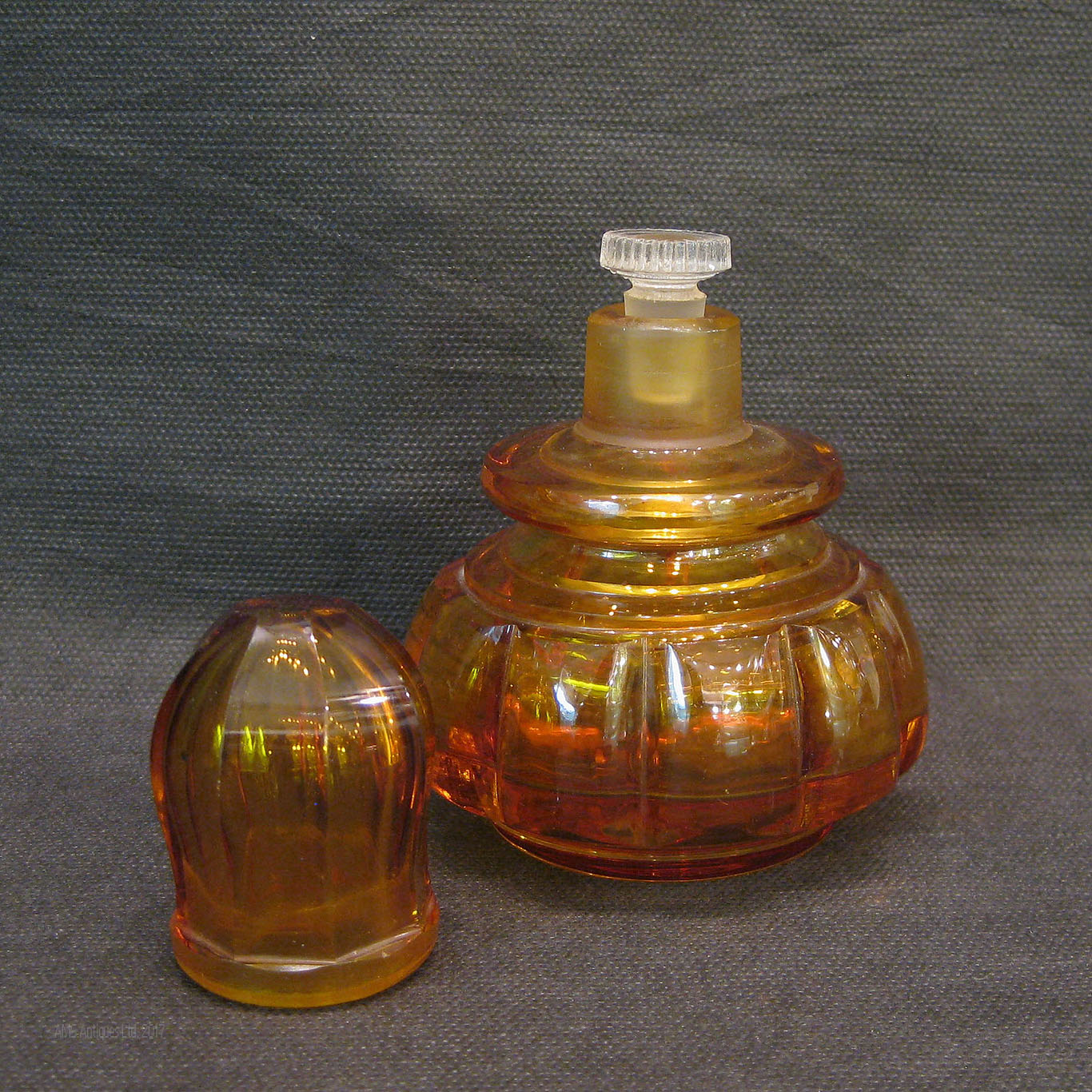 An amber Studio glass perfume bottle.
