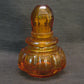 An amber Studio glass perfume bottle.