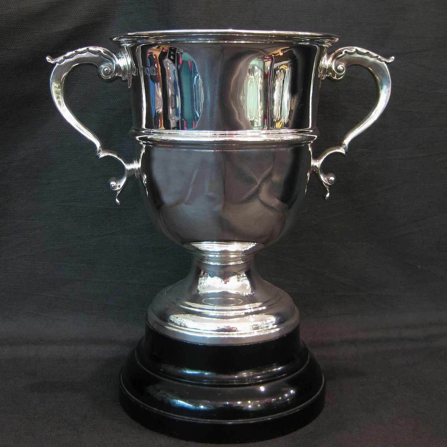 An elegant Silver Trophy on wooden base.